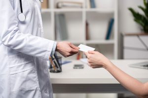 doctor handing patient a prescription of cannabis for chronic pain