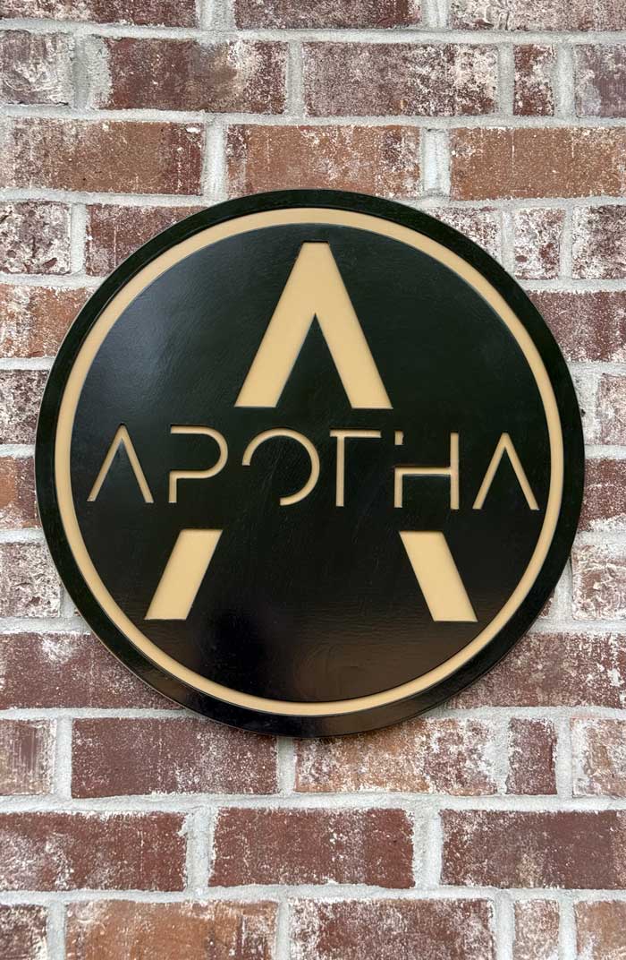 Apotha sign on a brick wall